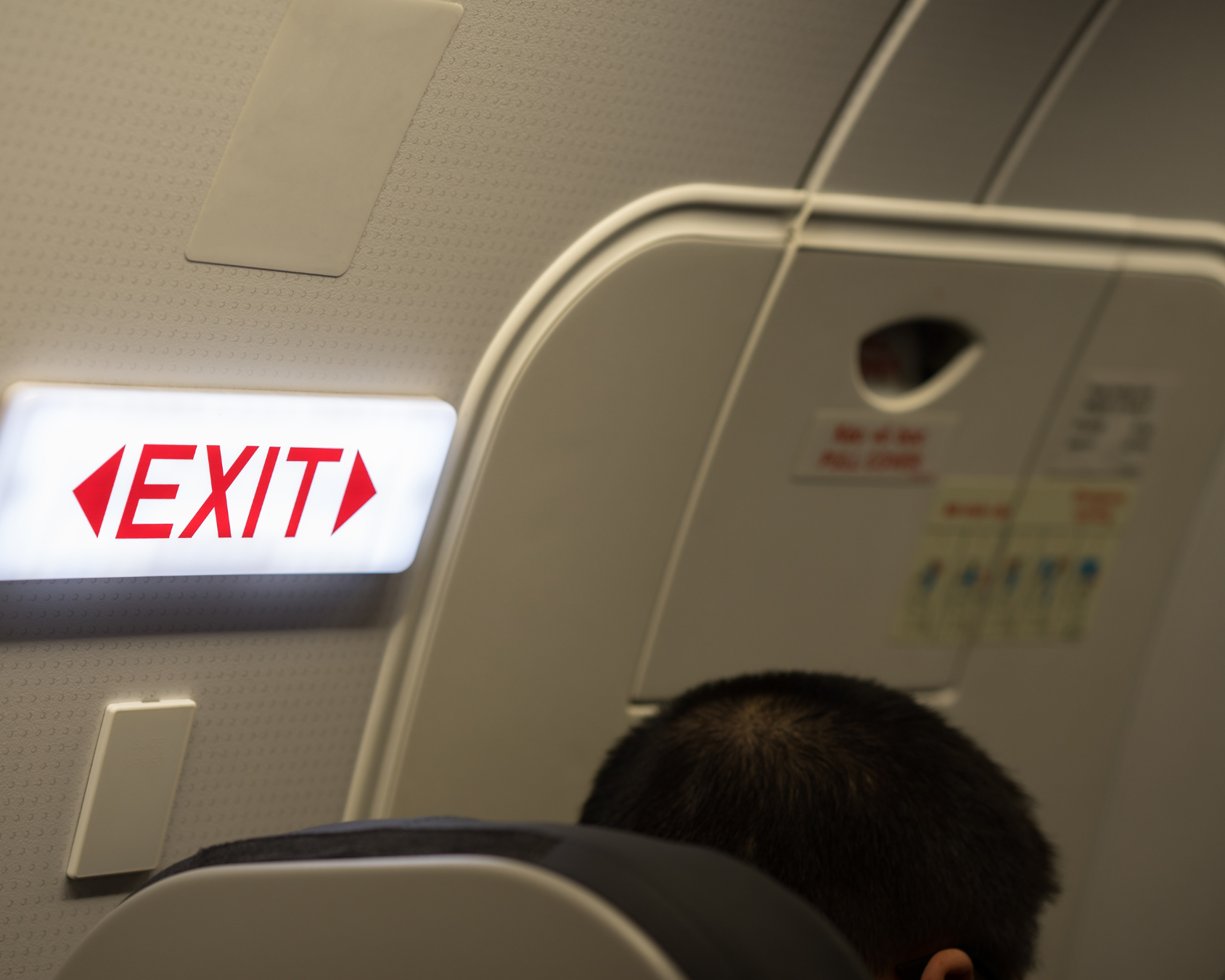 Can children sit in the emergency exit seat?